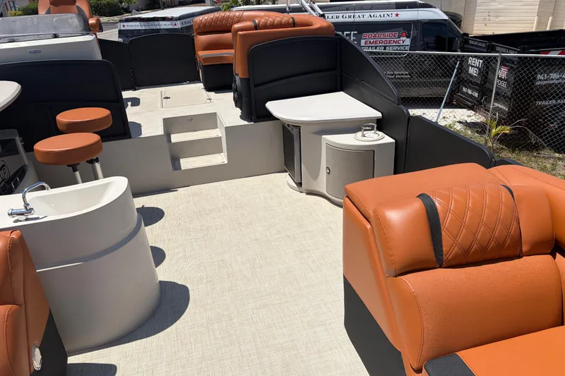 Slide: The Image of Luxurious interior of a 2015 Premier 290 Grand View boat with orange seating and amenities. - 22