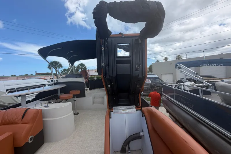 Slide: The Image of 2015 Premier 290 Grand View pontoon boat interior with seating and helm station. - 47