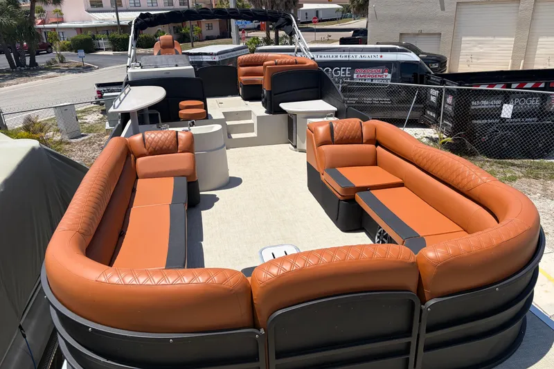 Slide: The Image of Luxurious 2015 Premier 290 Grand View pontoon boat with spacious orange seating and modern amenities. - 25