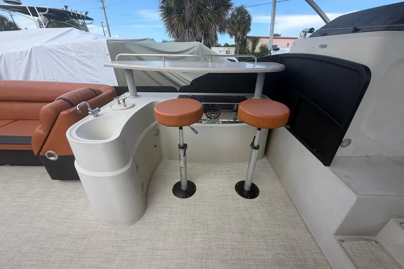 Slide: The Image of Interior of 2015 Premier 290 Grand View boat with bar stools and sink. - 44