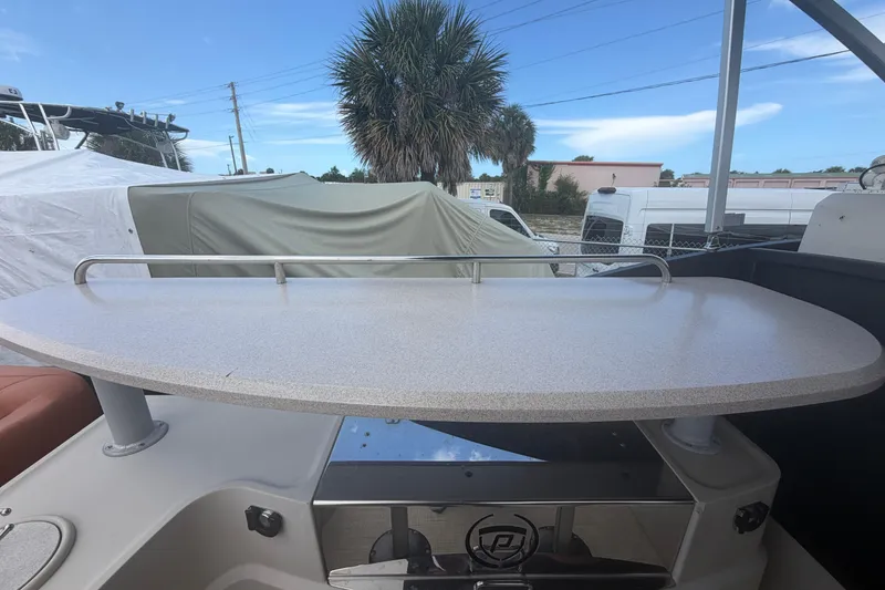 Slide: The Image of Premier 290 Grand View 2015 boat interior with table and railing, outdoor setting. - 70
