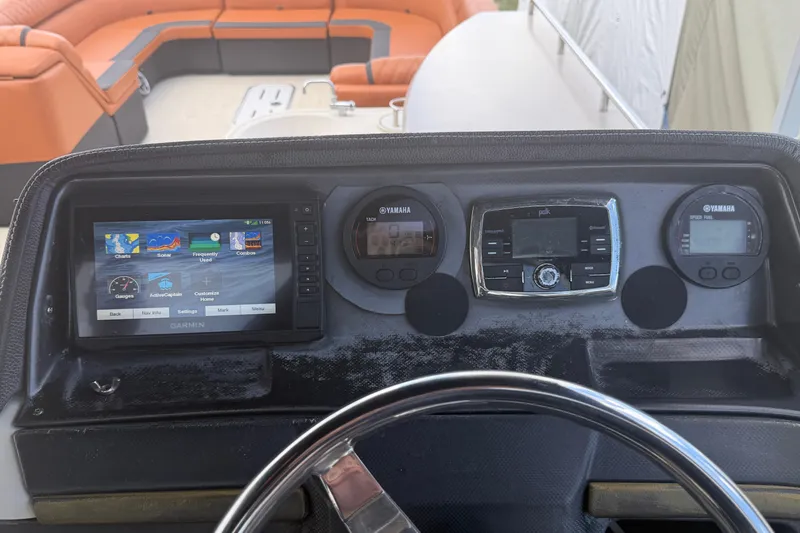 Slide: The Image of Dashboard of a 2015 Premier 290 Grand View boat with Garmin and Yamaha displays. - 63