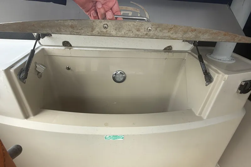 Slide: The Image of Open storage compartment on a 2015 Premier 290 Grand View boat. - 76