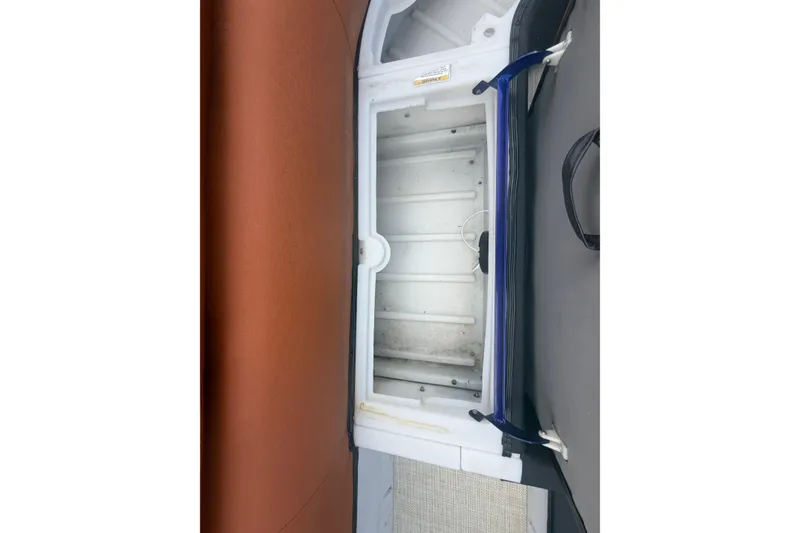 Slide: The Image of Open storage compartment in 2015 Premier 290 Grand View boat interior. - 54
