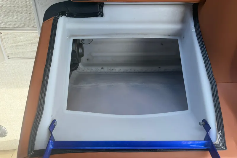Slide: The Image of Open storage compartment in 2015 Premier 290 Grand View boat interior. - 59