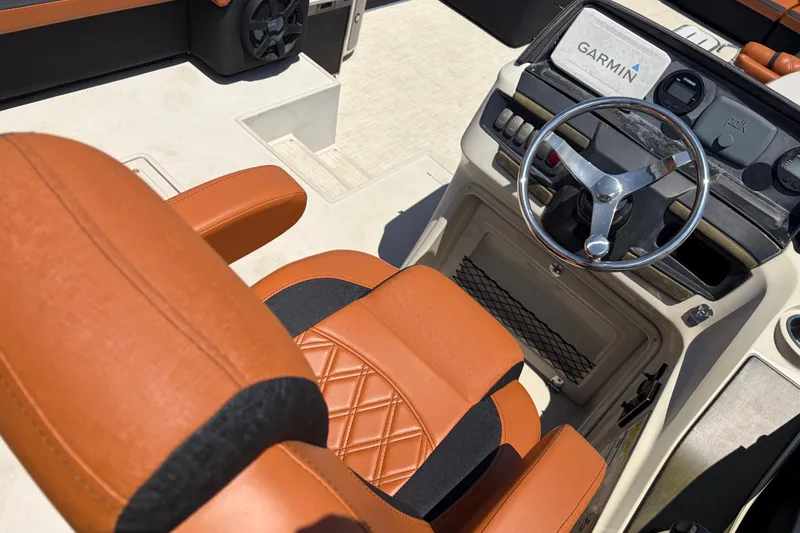 Slide: The Image of Captain's seat and helm of 2015 Premier 290 Grand View boat with Garmin navigation. - 31