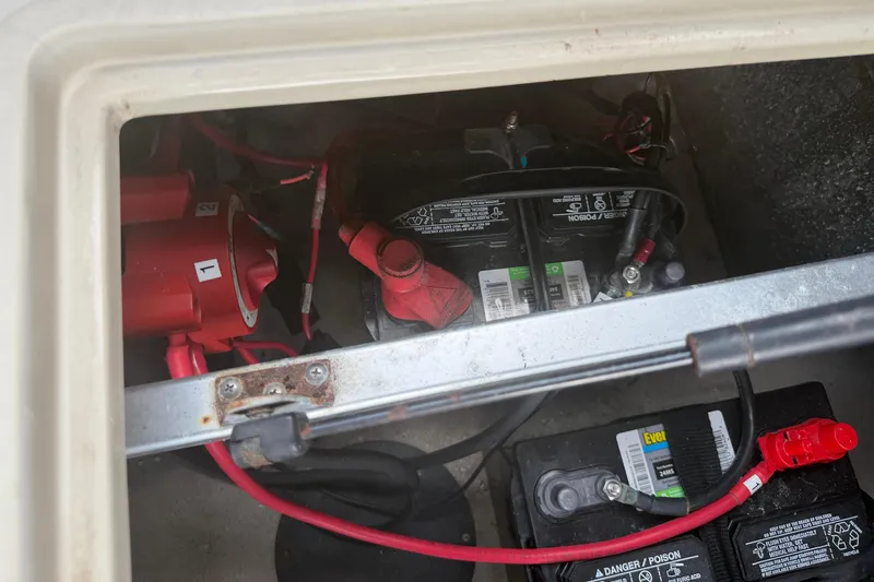 Slide: The Image of Battery compartment of a 2015 Premier 290 Grand View boat, showing wiring and connections. - 84