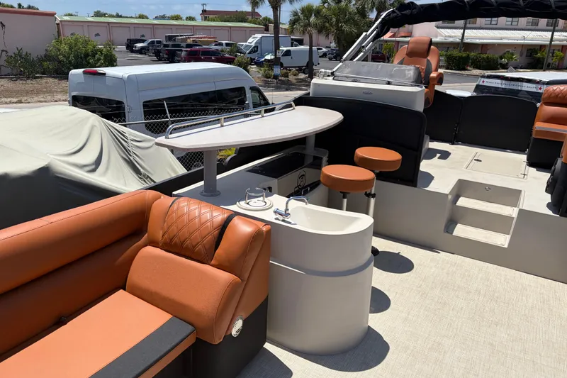 Slide: The Image of Luxurious interior of 2015 Premier 290 Grand View pontoon boat with seating and sink. - 23