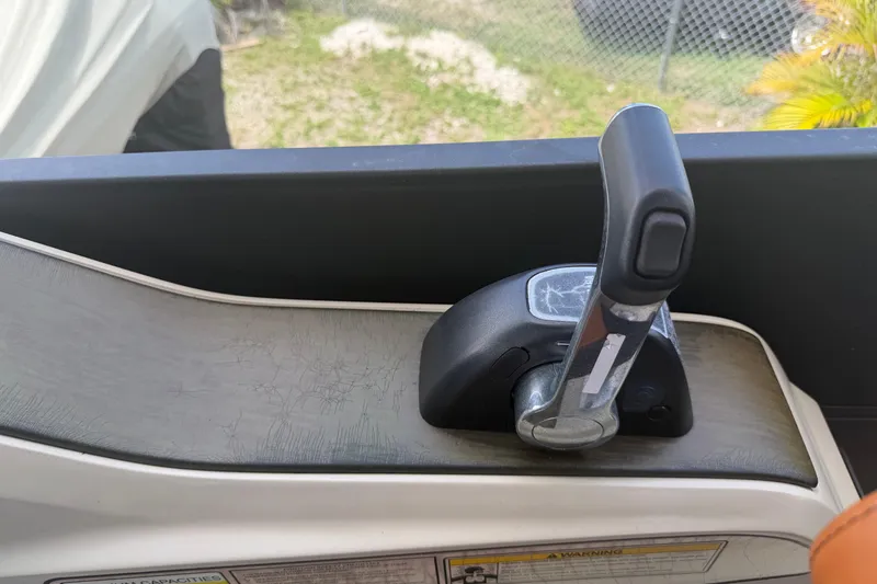 Slide: The Image of Throttle control lever on a 2015 Premier 290 Grand View boat. - 86