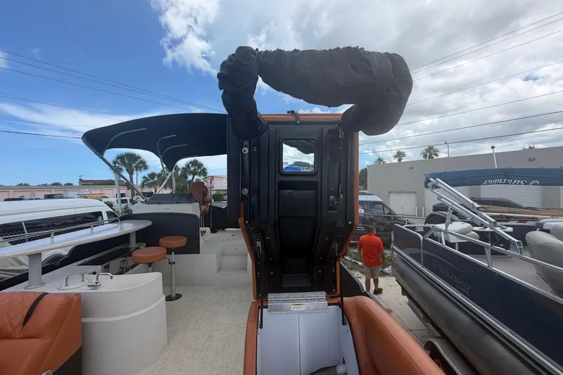 Slide: The Image of 2015 Premier 290 Grand View pontoon boat with seating and canopy, docked outdoors. - 48