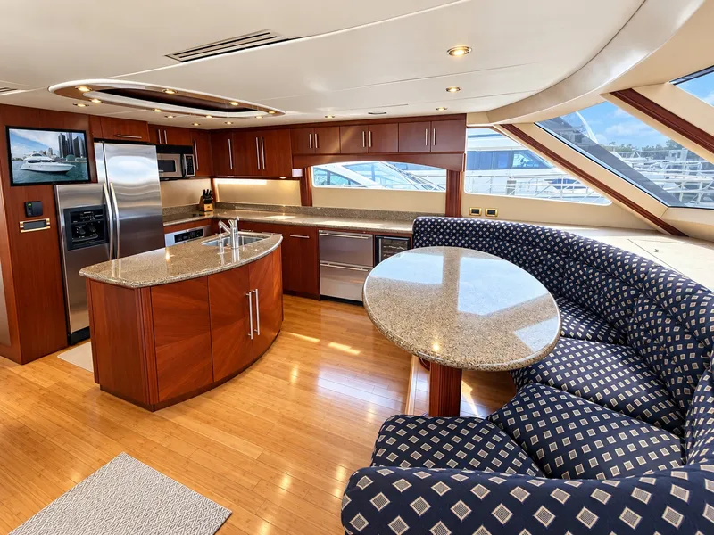 Slide: The Image of The 2002 Lazzara 80 Skylounge features an elegant kitchen with granite surfaces and a cozy seating area. - 39