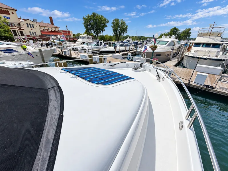 Slide: The Image of The image shows the deck of a 2002 Lazzara 80 Skylounge in a marina. - 28