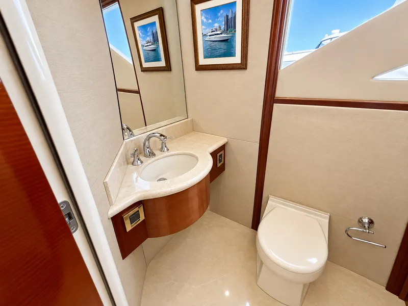 Slide: The Image of Luxurious bathroom with sink, toilet, and framed picture on the wall. - 45