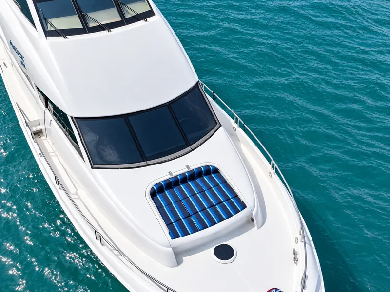 Slide: The Image of The 2002 Lazzara 80 Skylounge features a sleek design with a large sunpad on the foredeck. - 13