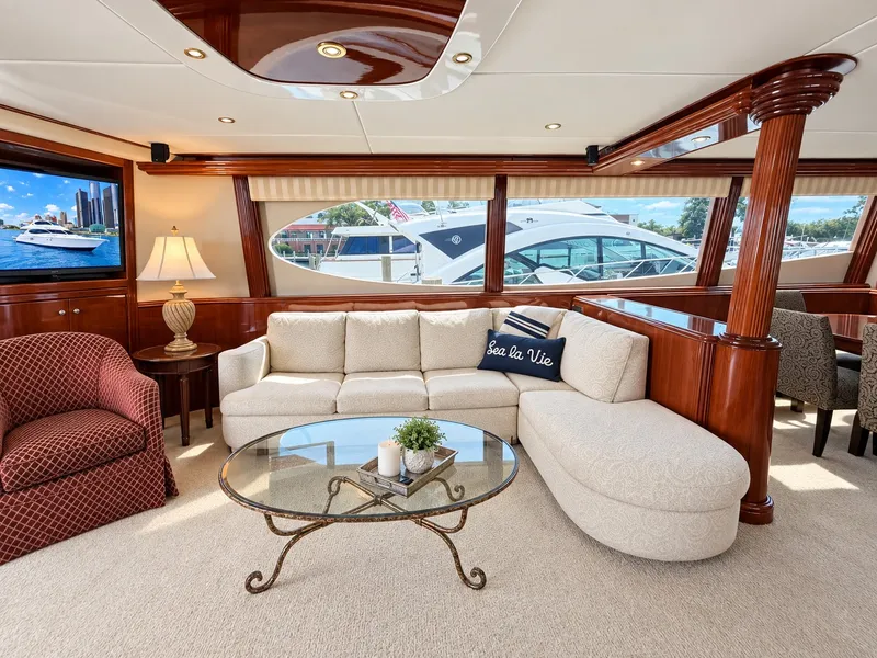 Slide: The Image of Luxurious salon with cream sofa, glass table, and elegant wood accents on a yacht. - 34