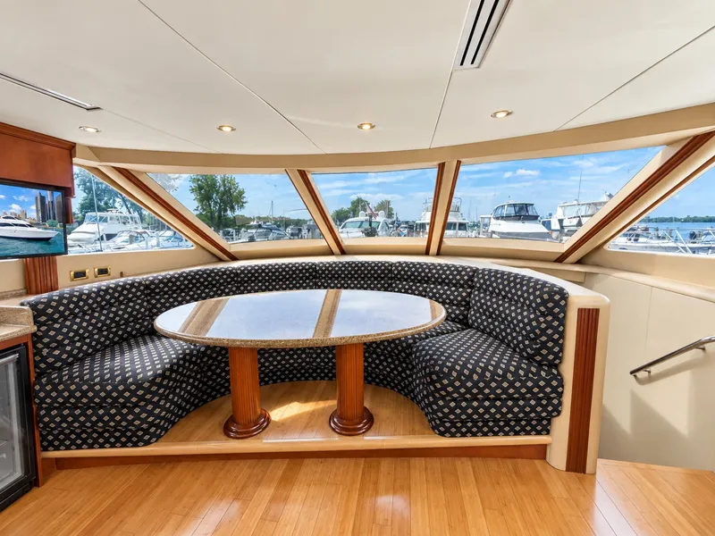 Slide: The Image of Interior of the 2002 Lazzara 80 Skylounge with a round seating area and large windows. - 41