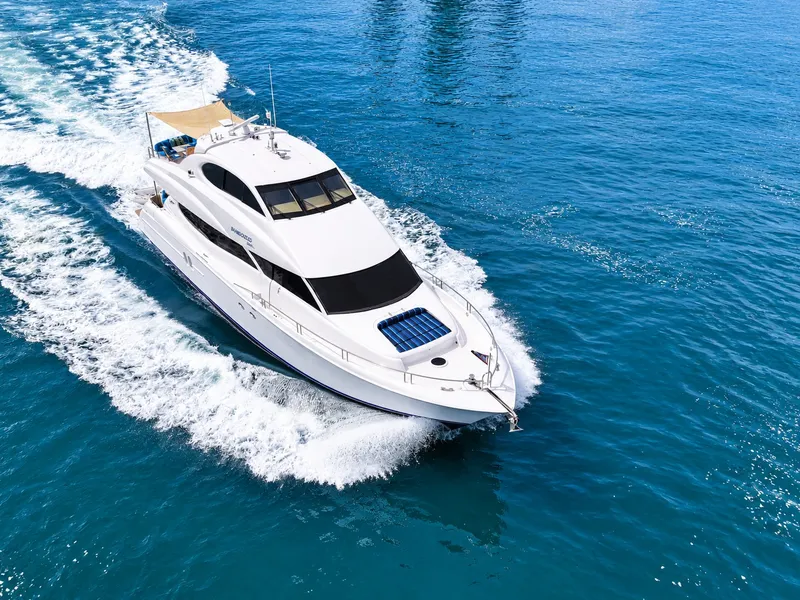 Slide: The Image of 2002 Lazzara 80 Skylounge cruising on open water, featuring sleek design and spacious deck. - 14