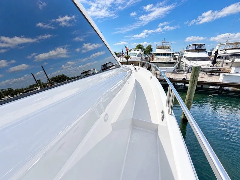 Slide: The Image of The 2002 Lazzara 80 Skylounge is docked, featuring sleek, modern design elements. - 26