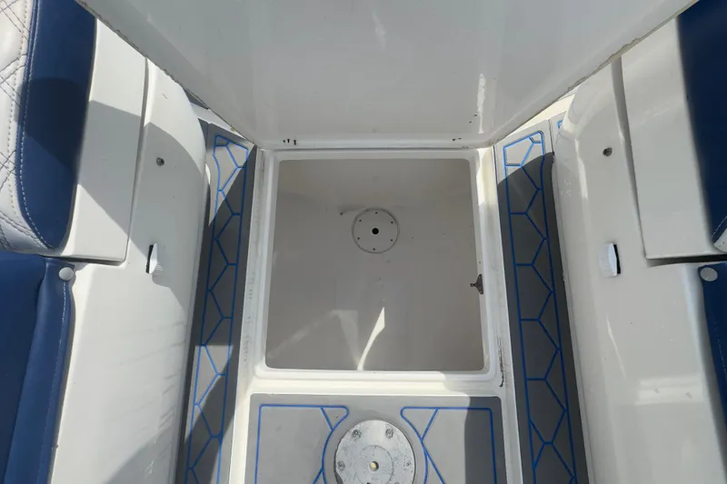 Slide: The Image of 2007 Intrepid 370 Center Console interior with storage compartment and blue seating. - 54