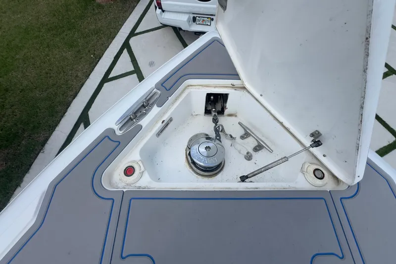 Slide: The Image of 2007 Intrepid 370 Center Console anchor compartment with open hatch and visible winch. - 49