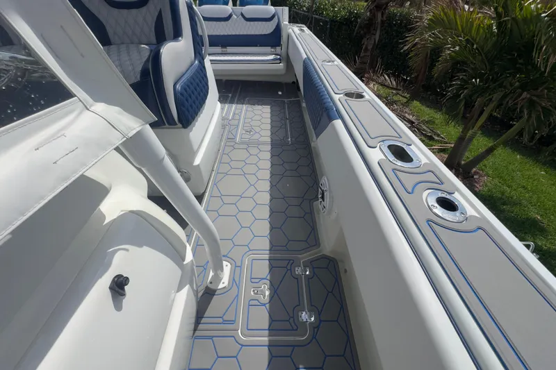 Slide: The Image of 2007 Intrepid 370 Center Console boat interior with blue and white seating and hexagonal flooring. - 60