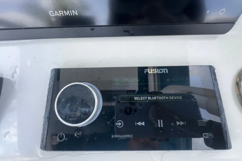 Slide: The Image of Control panel of a 2007 Intrepid 370 Center Console with Fusion Bluetooth device. - 77