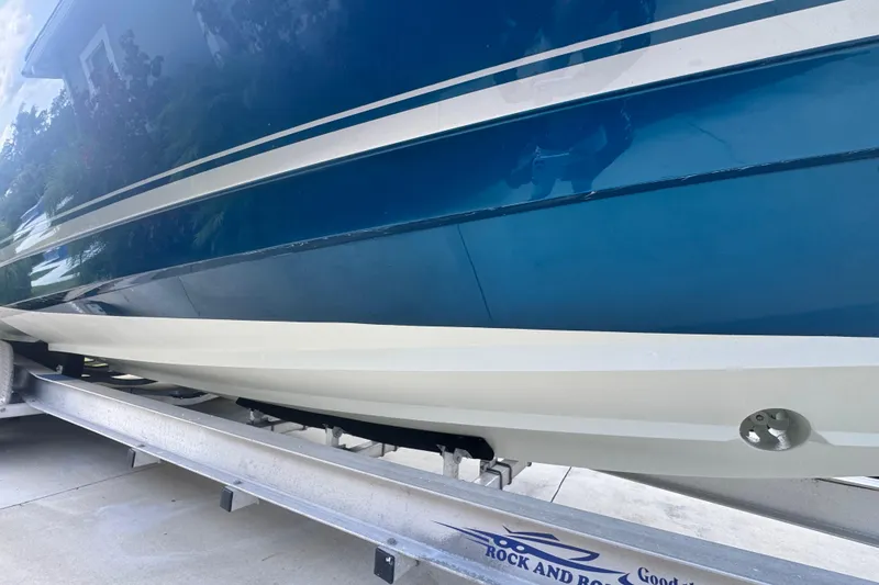 Slide: The Image of 2007 Intrepid 370 Center Console boat on trailer, showcasing sleek blue hull design. - 21
