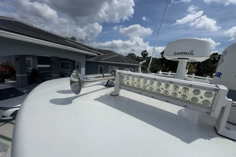 Slide: The Image of 2007 Intrepid 370 Center Console with Garmin radar and horn on deck under cloudy sky. - 89