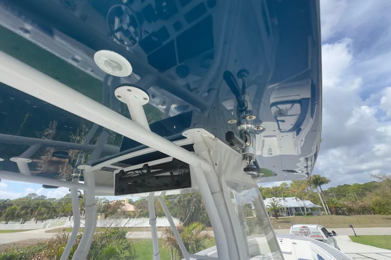 Slide: The Image of 2007 Intrepid 370 Center Console boat with sleek blue canopy and modern fixtures. - 86