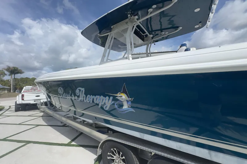 Slide: The Image of 2007 Intrepid 370 Center Console boat on trailer, labeled "Boss Therapy," under cloudy sky. - 16