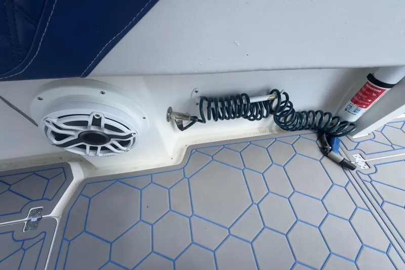 Slide: The Image of 2007 Intrepid 370 Center Console boat interior with speaker, coiled hose, and fire extinguisher. - 69