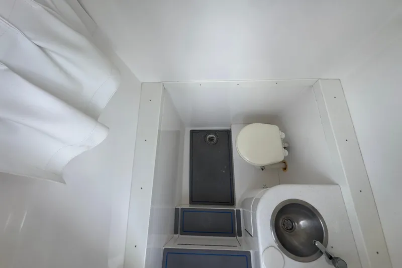 Slide: The Image of Compact bathroom in 2007 Intrepid 370 Center Console boat with toilet and sink. - 92