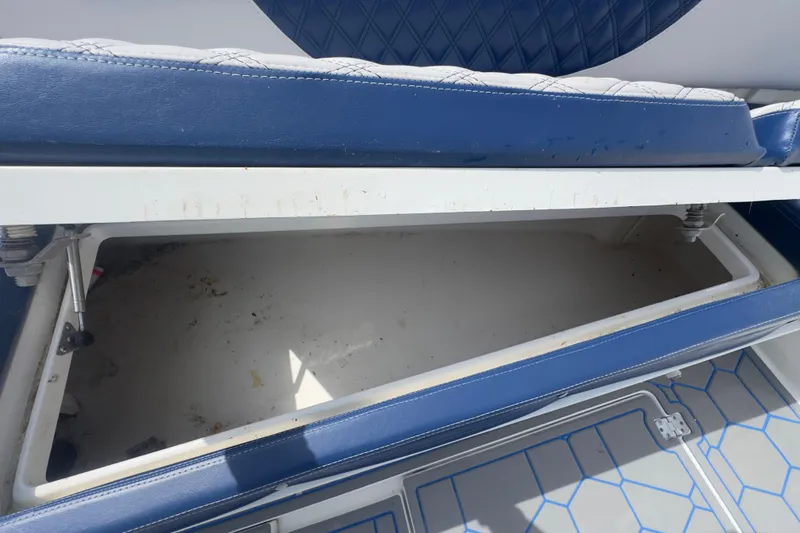 Slide: The Image of Open storage compartment on a 2007 Intrepid 370 Center Console boat with blue seating. - 51