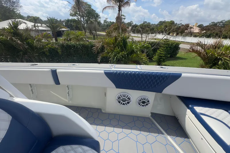 Slide: The Image of 2007 Intrepid 370 Center Console boat interior with blue and white seating, outdoor view. - 50