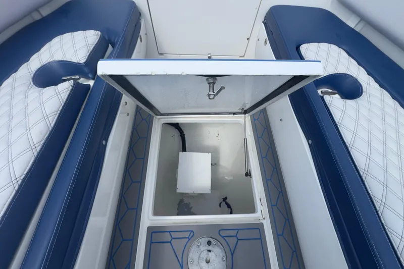 Slide: The Image of 2007 Intrepid 370 Center Console boat interior with open storage compartment and cushioned seating. - 53