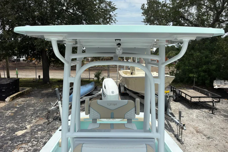Slide: The Image of 2024 Exuma 22 boat with T-top, parked outdoors, showcasing sleek design and modern features. - 23