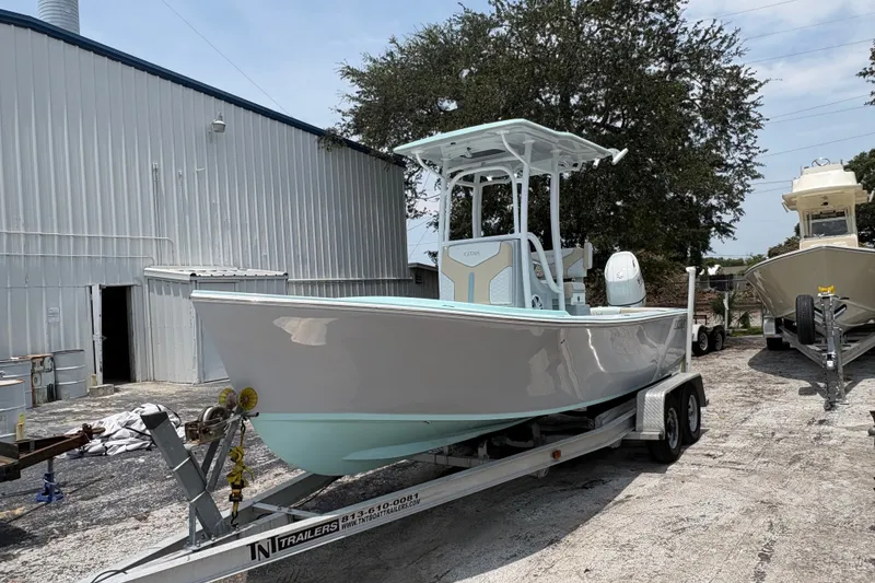 Slide: The Image of 2024 Exuma 22 boat on trailer outside a warehouse. - 8