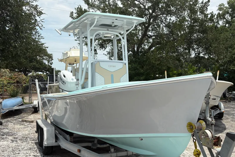 Slide: The Image of 2024 Exuma 22 boat on trailer, sleek design, parked outdoors. - 1