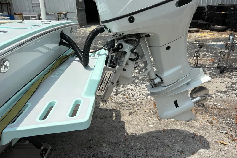 Slide: The Image of 2024 Exuma 22 boat with outboard motor and swim platform, displayed outdoors. - 5
