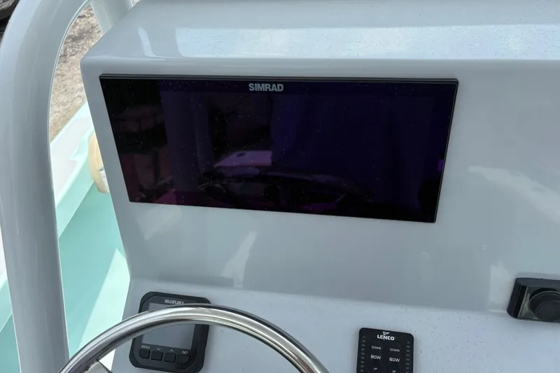 Slide: The Image of 2024 Exuma 22 boat dashboard with Simrad display and steering wheel. - 18