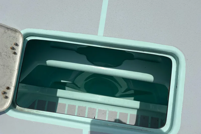 Slide: The Image of Open hatch on 2024 Exuma 22 boat, showing interior compartment. - 32