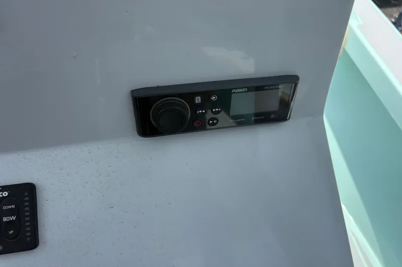 Slide: The Image of Control panel on 2024 Exuma 22 boat dashboard with Fusion stereo system. - 21