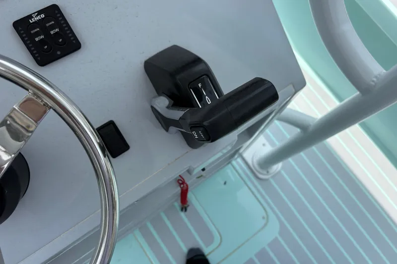 Slide: The Image of Control panel of 2024 Exuma 22 boat with steering wheel and throttle lever. - 20