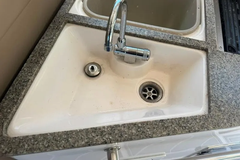 Slide: The Image of Sink with chrome faucet on 2015 Regal 35 Sport Coupe boat. - 56
