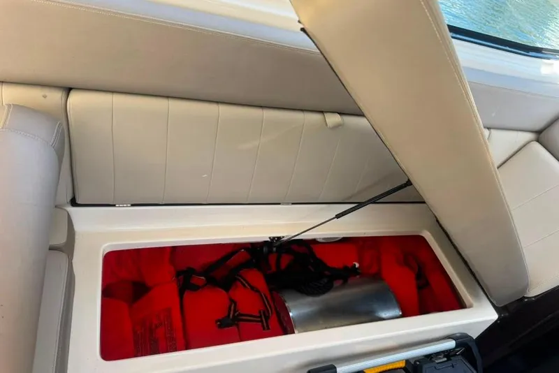 Slide: The Image of Storage compartment in a 2015 Regal 35 Sport Coupe, containing life jackets and equipment. - 67