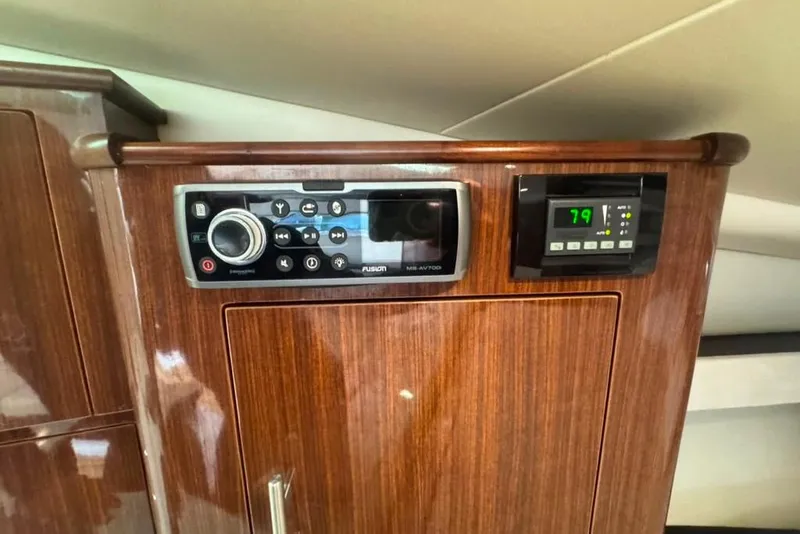 Slide: The Image of Control panel on 2015 Regal 35 Sport Coupe with wood finish and digital display. - 62