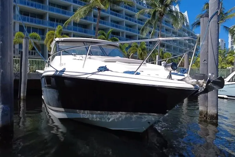 Slide: The Image of 2015 Regal 35 Sport Coupe docked near palm trees and modern buildings. - 17
