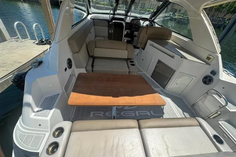 Slide: The Image of Interior view of a 2015 Regal 35 Sport Coupe boat with seating and table. - 20