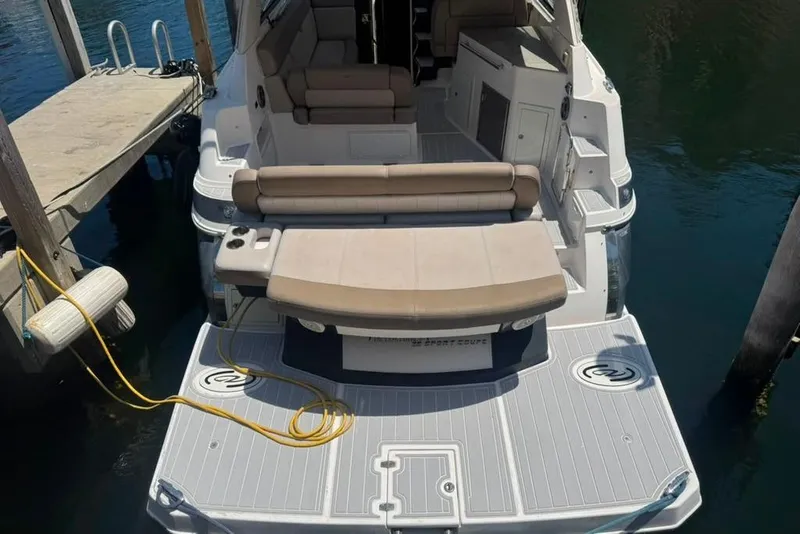 Slide: The Image of 2015 Regal 35 Sport Coupe docked, featuring spacious seating and swim platform. - 19