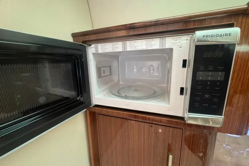 Slide: The Image of Open Frigidaire microwave in 2015 Regal 35 Sport Coupe yacht kitchen. - 50